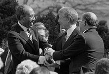 220px-Sadat_Carter_Begin_handshake_(cropped)_-_USNWR.jpg